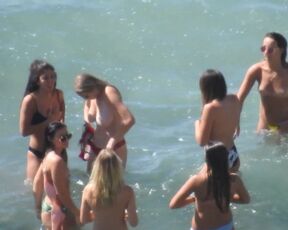 bikini girls are topless on the sea