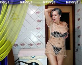 Hot housewife Lukerya having fun flirting in the kitchen. Easy home striptease of an old woman on a webcam online.