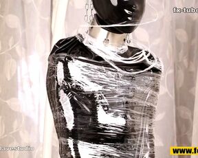 Fejira com Full body wrapped in tight latex clothing and plastic wrap